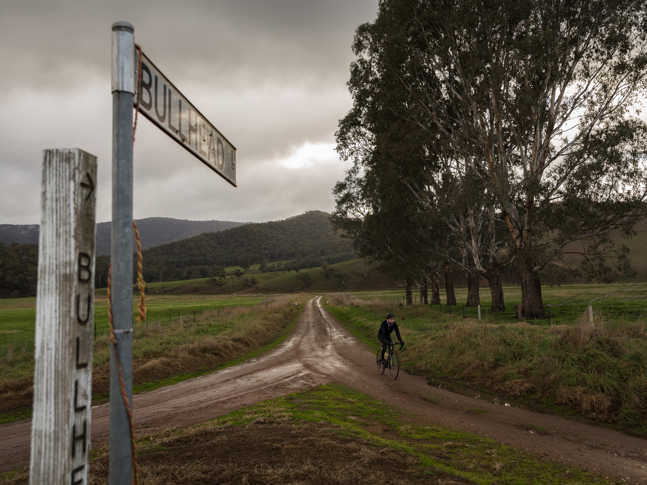 Riding on gravel roads in the Mitta Valley with gloomy skies overhead